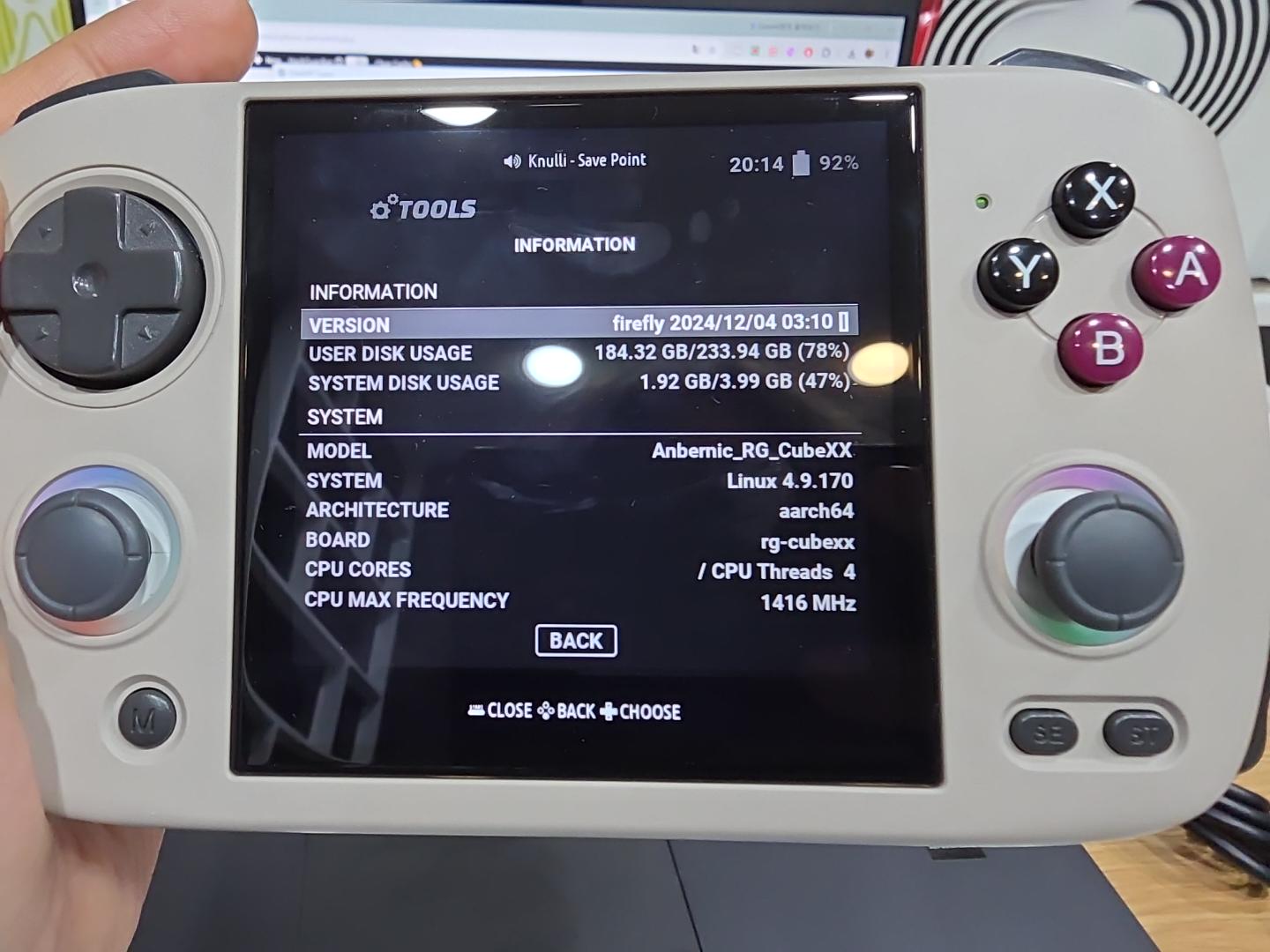 KNULLI Firefly information screen on an Anbernic RG CubeXX showing version 2024/12/04 03:10, aarch64 architecture, and rg-cubexx board